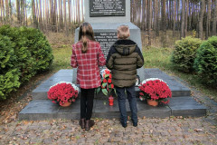 Uczniowie podczas składania   kwiatów pod pomnikiem